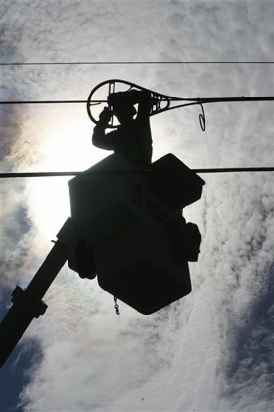 Bolstered by billions in federal stimulus money, the effort to expand broadband Internet access to rural areas has parallels to the electrification of rural Appalachia in the 1930s. In this Oct. 2, 2007 file photo, A.J. Bowen of Schupp's Line Construction, Inc. works on fiber-optic installation in Norton, Vt.